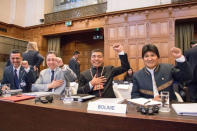 Bolivian President Evo Morales (R) gestures as he arrives for the opening of hearings at the World Court in The Hague, Netherlands March 19, 2018. REUTERS/David Morales