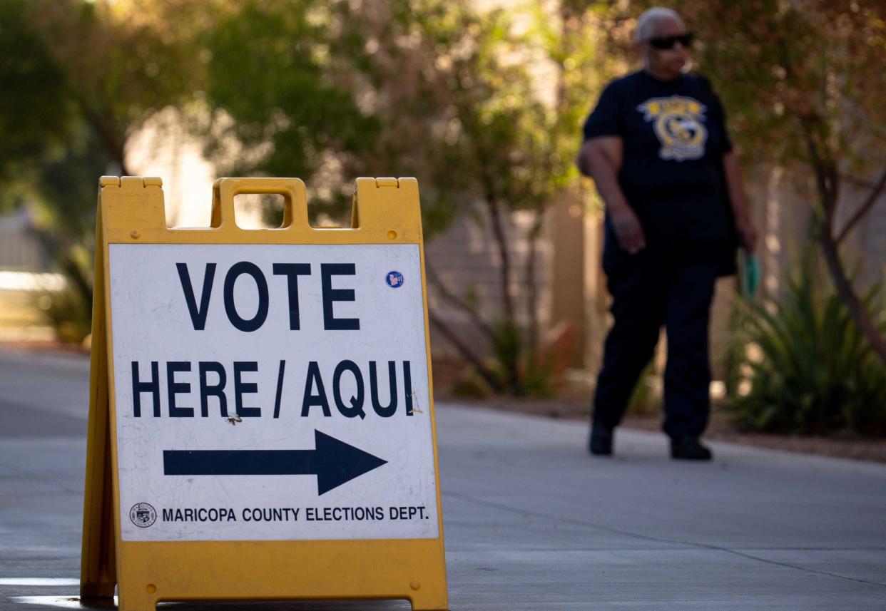 A voter arrives to drop off her ballot, Aug. 4, 2020, at the Mesa Community College polling place.