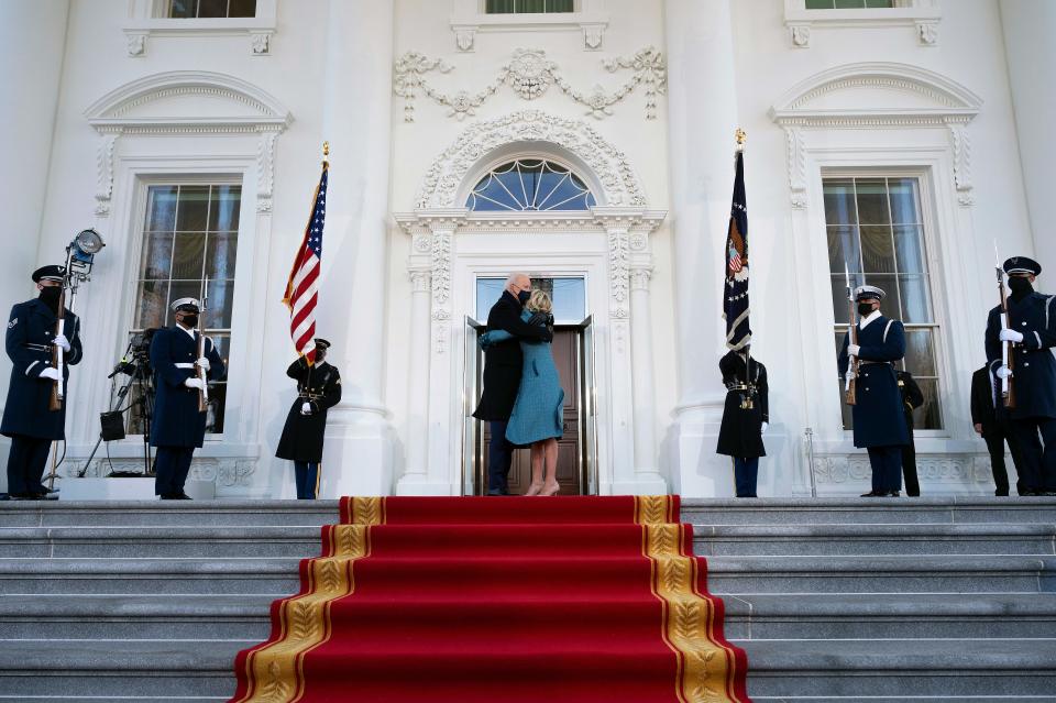 President Joe Biden (C L) hugs First Lady Jill Biden as they arrive at the White House in Washington, DC, on January 20, 2021. (Jim Watson/AFP via Getty Images)