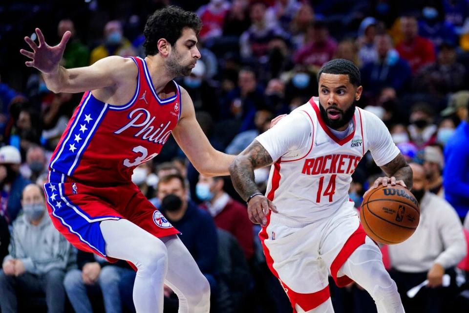 The Rockets' D.J. Augustin, 14, tries to get past the Sixers' Furkan Korkmaz.