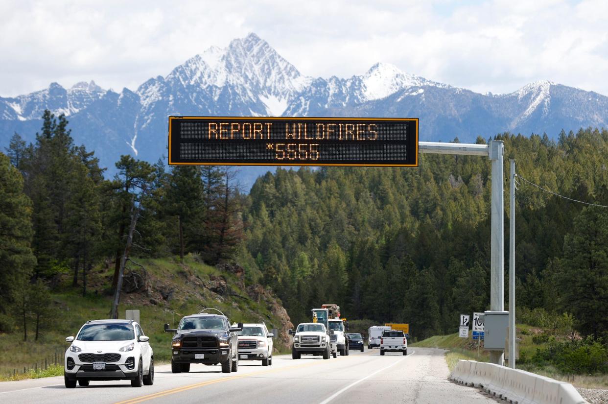 A sign about wildfire prevention is seen over a roadway in Cranbrook, British Columbia, on Friday, May 31, 2024.