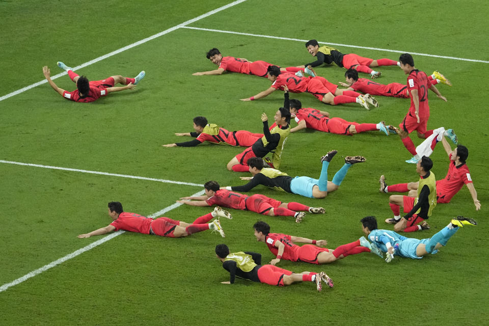 South Korea's team players celebrate after the World Cup group H soccer match between South Korea and Portugal, at the Education City Stadium in Al Rayyan, Qatar, Friday, Dec. 2, 2022. (AP Photo/Darko Bandic)