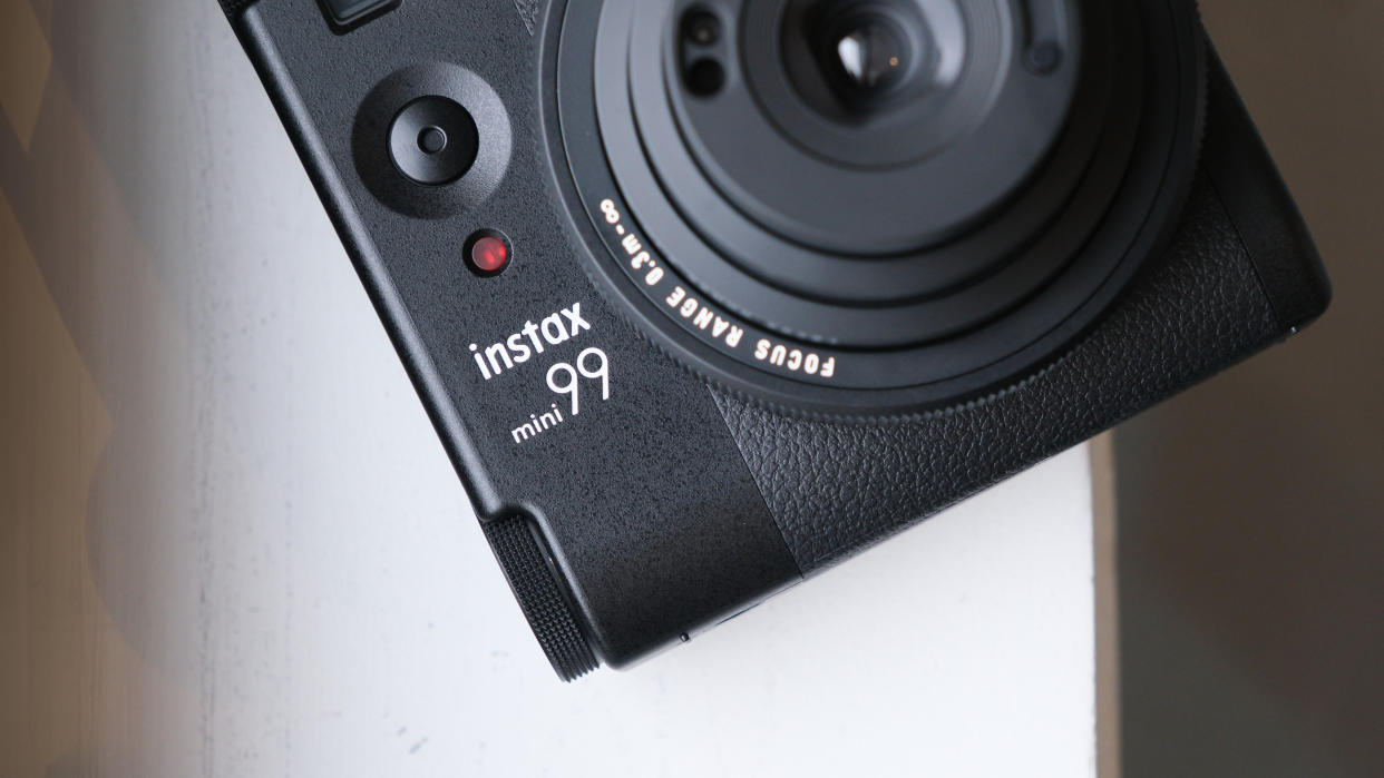  Fujifilm Instax Mini 99 instant camera on a white surface. 