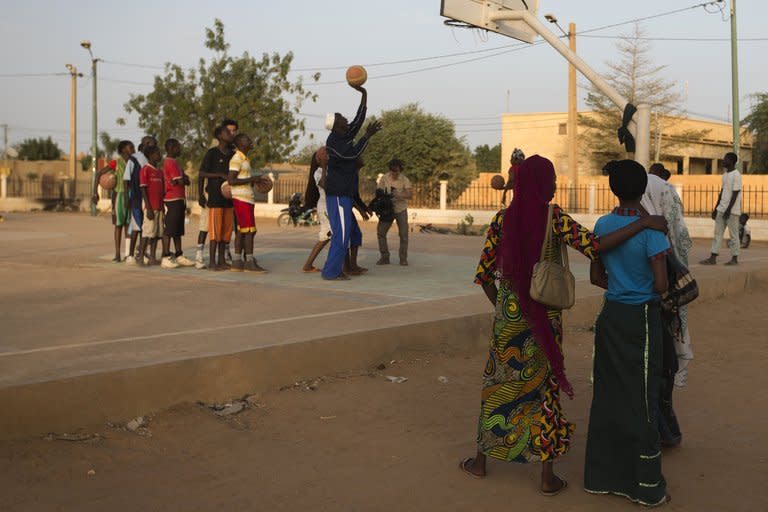 Local youngsters are seen playing basketball at the former "Sharia Square" in central Gao, on February 26, 2013. Since the departure of the Islamists, who occupied the city for nine months, following the arrival of the French and Malian forces, the central square of Gao is once again called "Independence square."