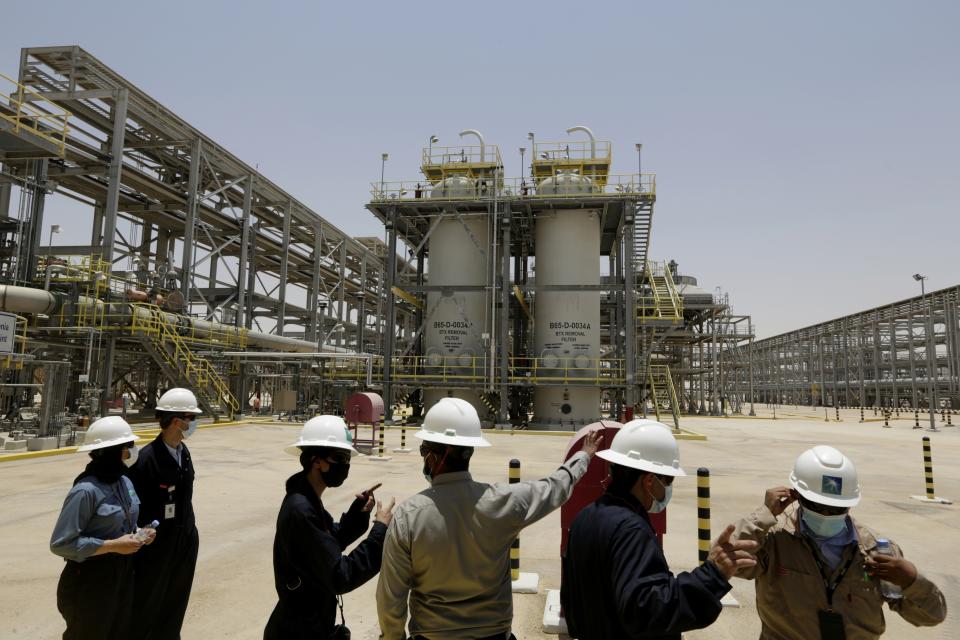 FILE - Saudi Aramco engineers and journalists look at the Hawiyah Natural Gas Liquids Recovery Plant in Hawiyah, in the Eastern Province of Saudi Arabia on June 28, 2021. The Middle East is one of the most vulnerable regions in the world to the impact of climate change, and already the effects are being seen. This year's annual U.N. climate change conference, known as COP27, is being held in Egypt in November 2022, throwing a spotlight on the region. (AP Photo/Amr Nabil, File)