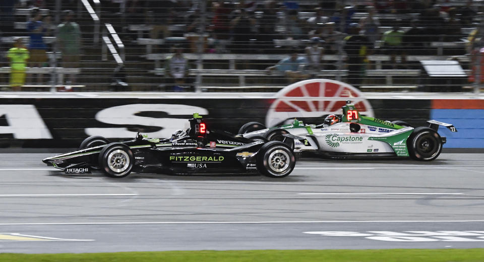 Josef Newgarden (2) leads Alexander Rossi (27) during the IndyCar auto race at Texas Motor Speedway, Saturday, June 8, 2019, in Fort Worth, Texas. Newgarden won the race. (AP Photo/Larry Papke)