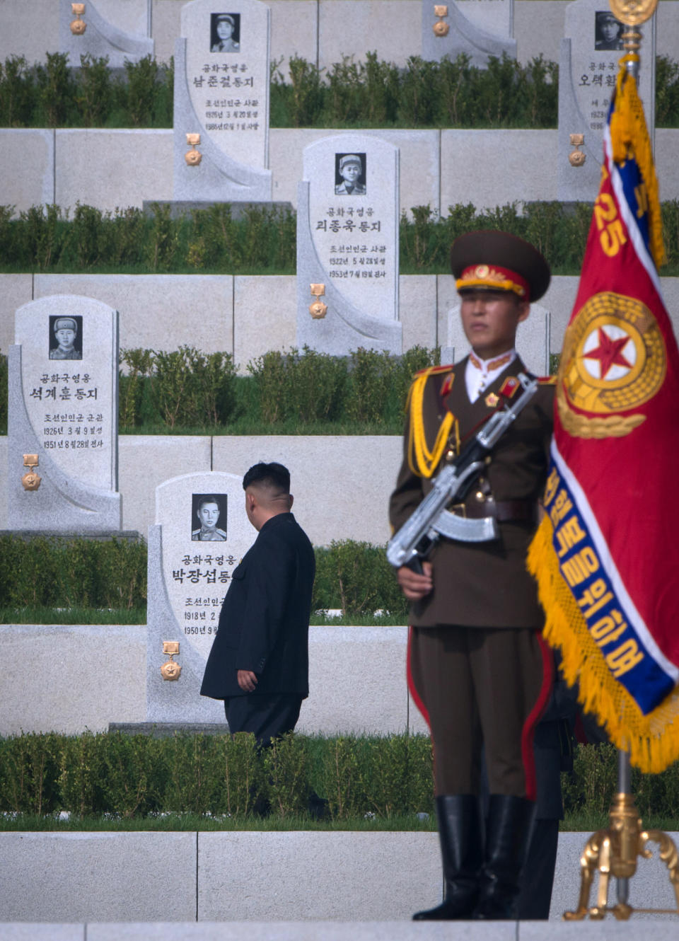 North Korean leader Kim Jong-Un (L) looks at tombstones during the inauguration of a Korean war military cemetery in Pyongyang on July 25, 2013. (Ed Jones/AFP/Getty Images)