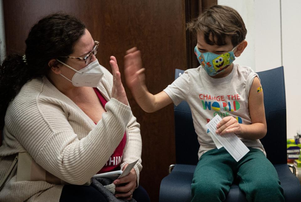 Lake Almaguer, 6, high-fives mother Summer after receiving his first dose of the Pfizer COVID-19 vaccine on Nov. 13 at La Palmera mall in Corpus Christi, Texas. (Angela Piazza/Caller-Times)