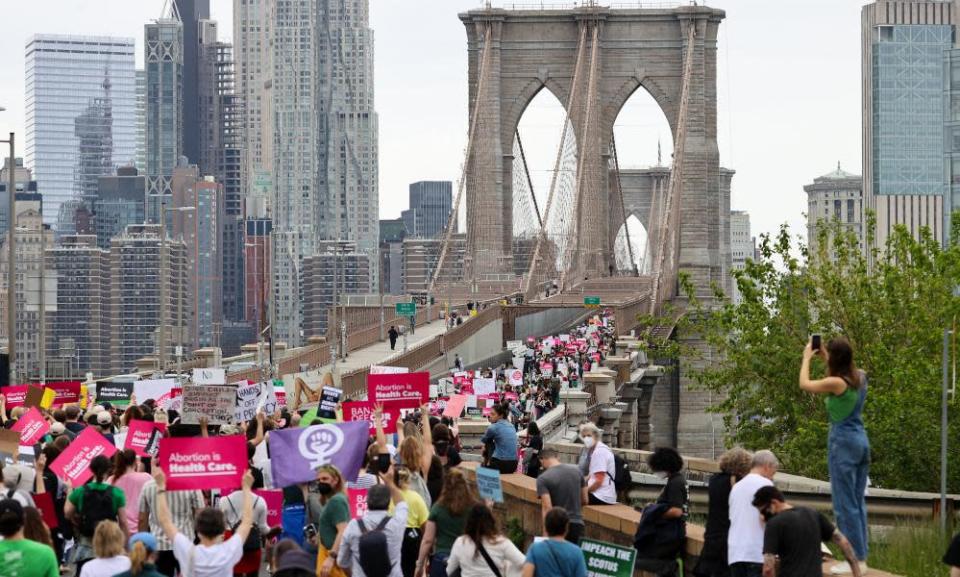 Thousands of people march for abortion rights across the Brooklyn Bridge in New York City.