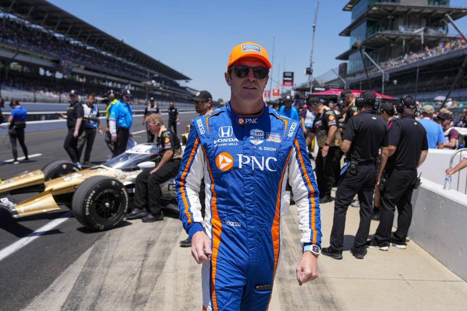 Scott Dixon, of New Zealand, walks to his car before the start of qualifications for the Indianapolis 500 auto race at Indianapolis Motor Speedway in Indianapolis, Sunday, May 21, 2023. (AP Photo/Michael Conroy)