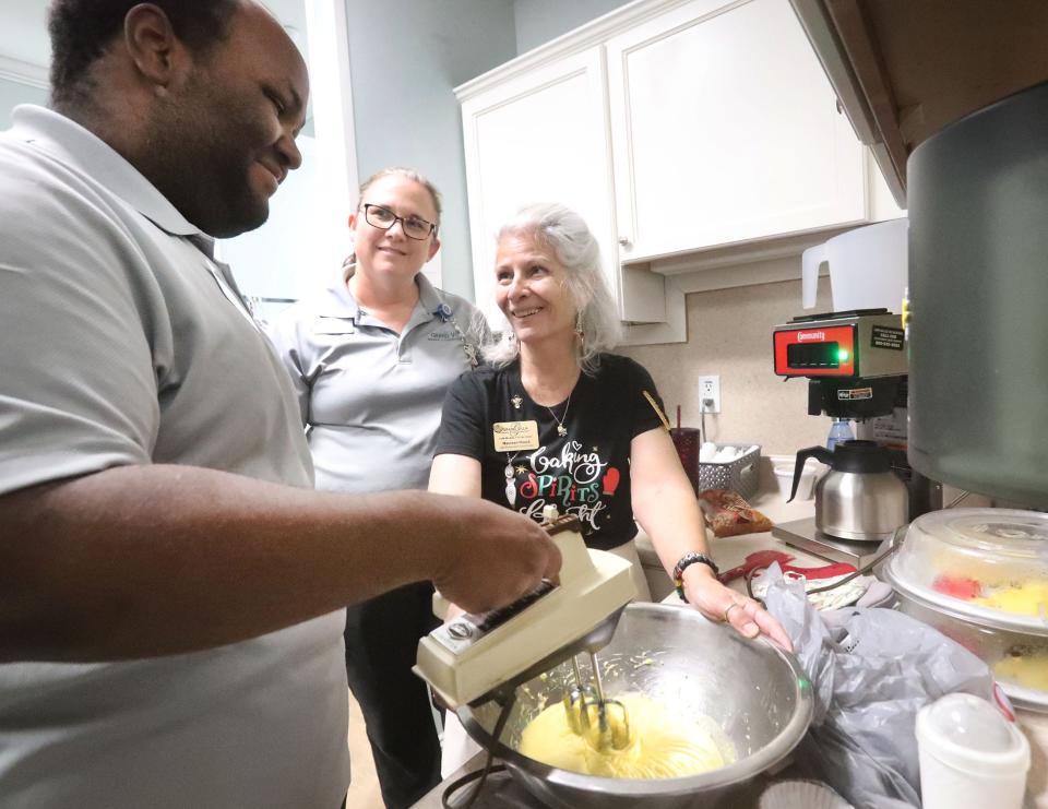 Project SEARCH student Antonio Byrd mixes cookie dough with skills trainer Amie Smith and Maureen Hauck, Thursday, Dec. 15, 2022, at Grand Villa in Palm Coast. Project SEARCH is a national program for students with disabilities who complete one-year internships to gain work experience and employability skills.