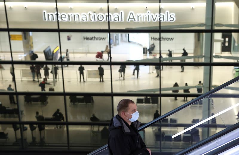 A person goes up an escalator at Terminal 2 of Heathrow Airport, amid the coronavirus disease (COVID-19) outbreak in London