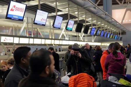 Passengers wait in the departures area of Terminal 4 at John F. Kennedy International Airport following a series of flight cancellations and delays, and a water main break in the arrivals area in New York City, U.S. January 7, 2018. REUTERS/Andrew Kelly