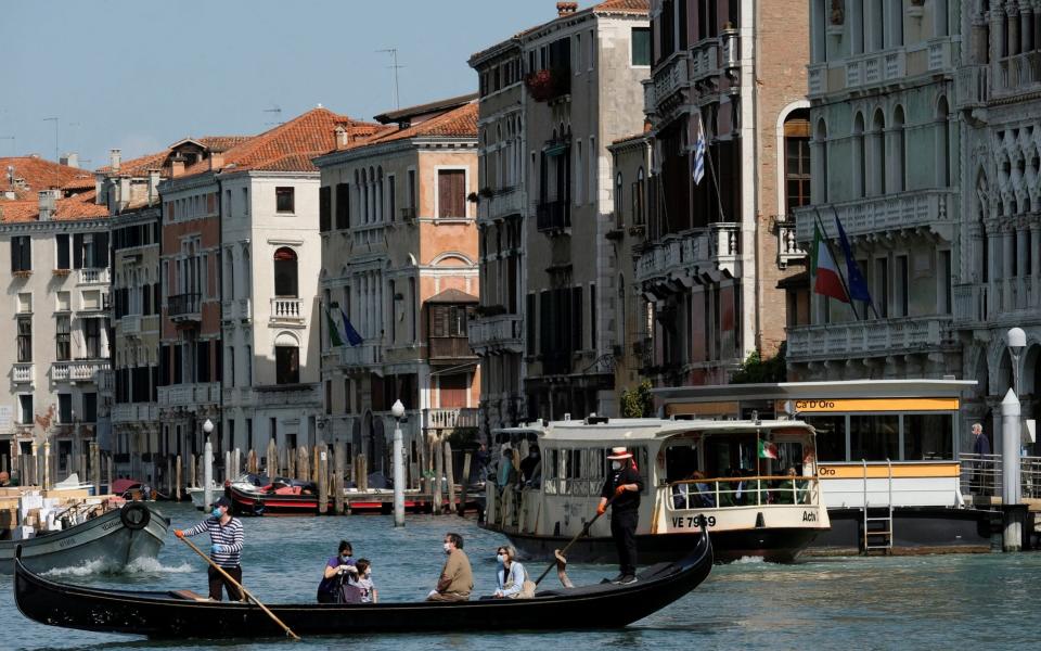 Gondoliers resume their service on the Grand Canal as Italy eases some more of the lockdown measures put in place during the coronavirus disease - REUTERS