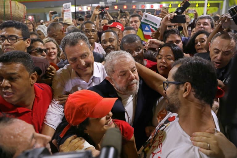 Former Brazilian president Luiz Inacio Lula da Silva plunges into a crowd during a three-week tour designed to show his continuing popularity ahead of next year's presidential election