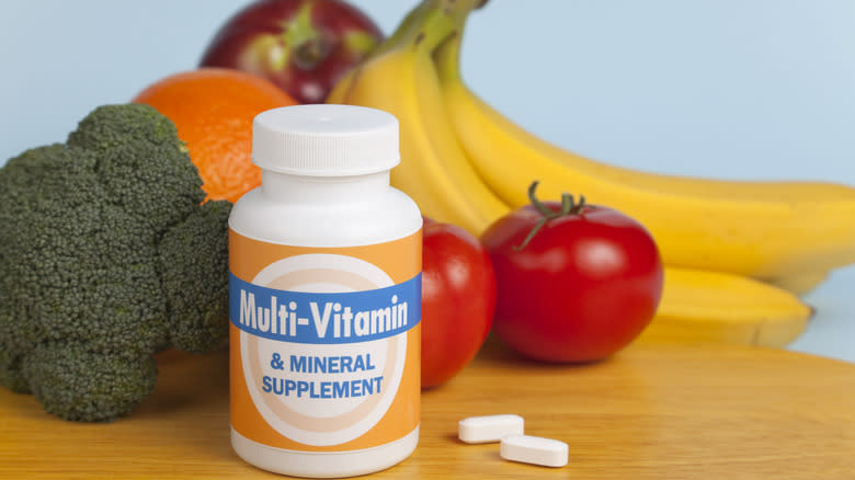 Multivitamin bottle and assorted fruit