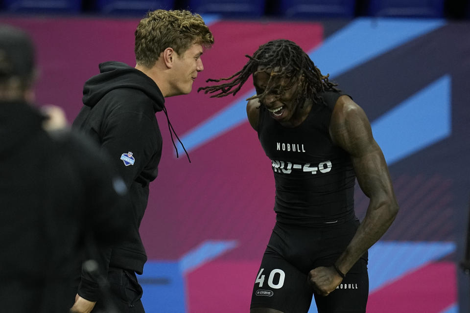 Texas wide receiver Xavier Worthy, right, celebrates with Iowa defensive back Cooper Dejean after running the 40-yard dash at the NFL football scouting combine, Saturday, March 2, 2024, in Indianapolis. (AP Photo/Darron Cummings)