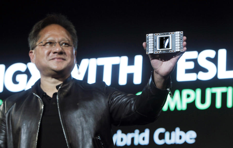 NVIDIA CEO Jen-Hsun Huang shows NEW HGX with TESLA V100 VERSA GPU CLOUD COMPUTING as he talks about AI and gaming during the Computex Taipei exhibition at the world trade center in Taipei, Taiwan, Tuesday, May 30, 2017. (AP Photo/Chiang Ying-ying)