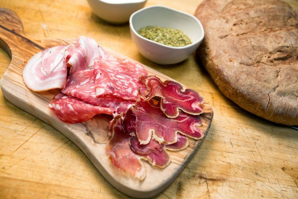 small charcuterie plate with ham, salami and prosciutto