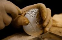 A worker from the Casa da Moeda do Brasil (Brazilian Mint) prepares a Rio 2016 Paralympic medal in Rio de Janeiro, Brazil, June 28, 2016. REUTERS/Sergio Moraes