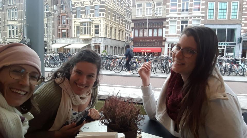 Bar Pereg, center, and her sisters, Noy Pereg, right, and Romit Pereg, left, at a cafe in Amsterdam.