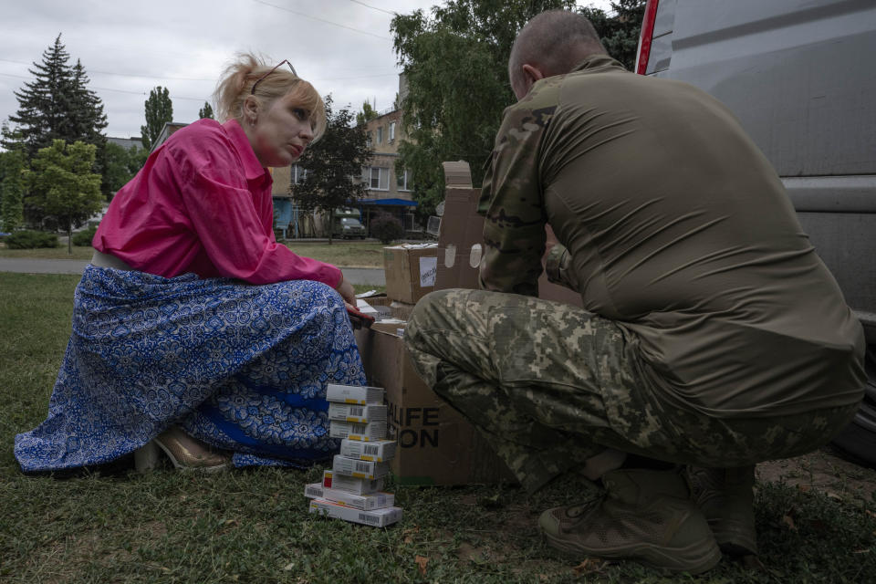 Medic volunteer Nataliia Voronkova, left, delivers medical aid to a hospital, in Kurakhove, Donetsk region, eastern Ukraine, Thursday, July 21, 2022. Voronkova has dedicated her life to aid distribution and tactical medical training for soldiers and paramedics, working on front line of the Donetsk region since the war began in 2014. (AP Photo/Nariman El-Mofty)