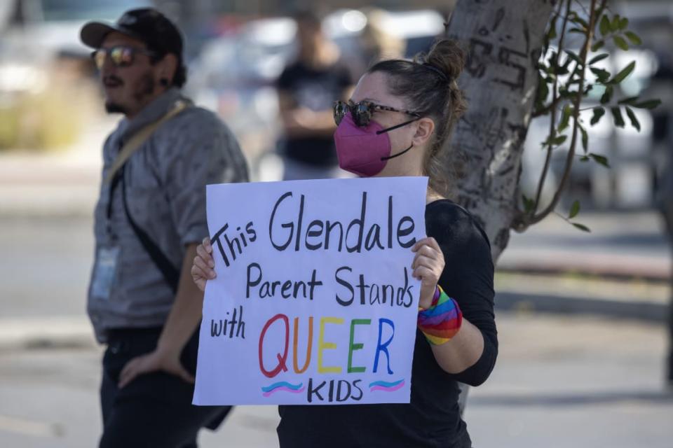 <div class="inline-image__caption"><p>A pro-LGBTQ+ demonstrator holds a sign outside a Glendale Unified School District (GUSD) Board of Education meeting/</p></div> <div class="inline-image__credit">David McNew</div>