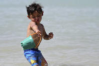 <p>Urijah Salcedo throws a bucket of water on himself while playing in Spring Valley Lake in Victorville Calif., June 19, 2017. (James Quigg/The Daily Press via AP) </p>