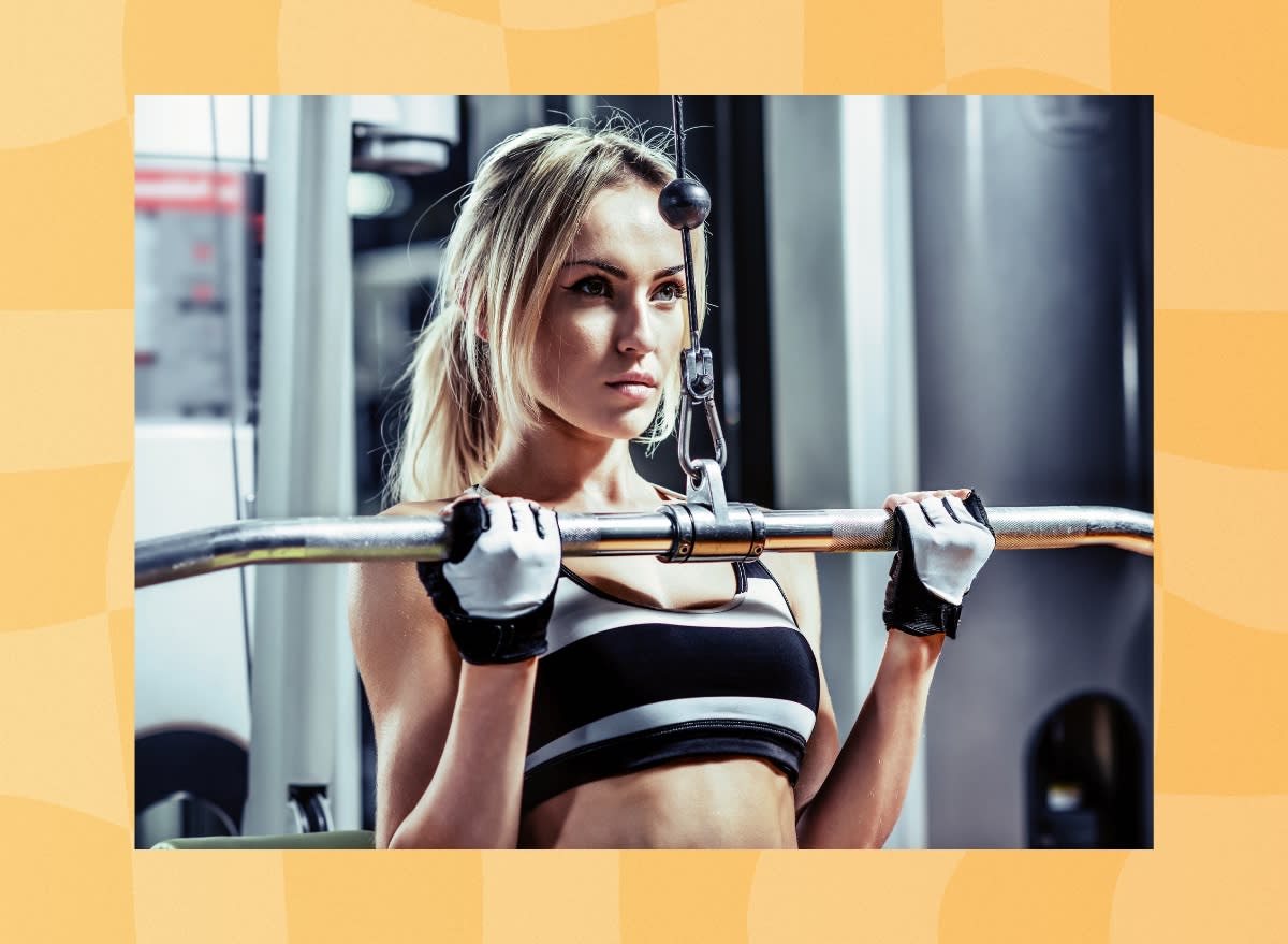 woman doing lat pulldown exercise at the gym