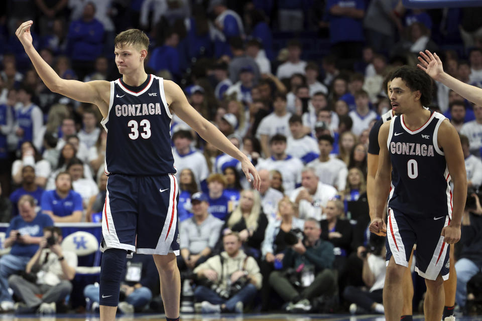 Gonzaga's Ben Gregg (33) and Ryan Nembhard (0) celebrate the team's win over Kentucky in an NCAA college basketball game Saturday, Feb. 10, 2024, in Lexington, Ky. (AP Photo/James Crisp)