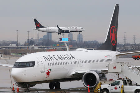 An Air Canada Boeing 737 MAX 8 from San Francisco approaches for landing at Toronto Pearson International Airport over a parked Air Canada Boeing 737 MAX 8 aircraft in Toronto, Ontario, Canada, March 13, 2019. REUTERS/Chris Helgren