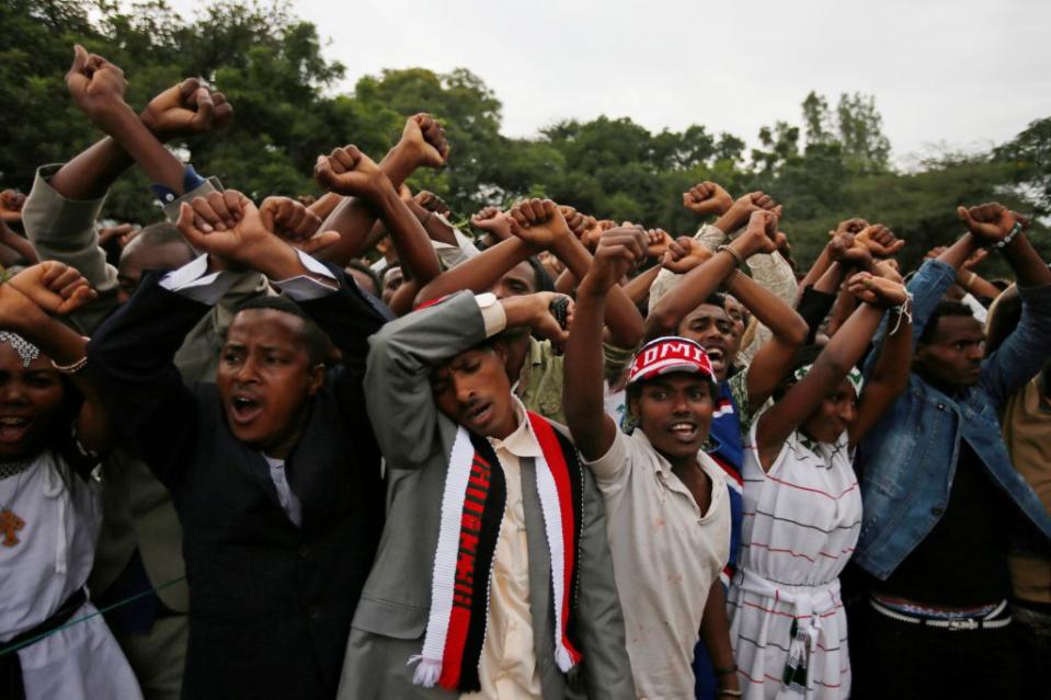 Demonstrators chant slogans while flashing the Oromo protest gesture during Irreecha, the thanksgiving festival of the Oromo people, in Bishoftu town, Oromia region, Ethiopia