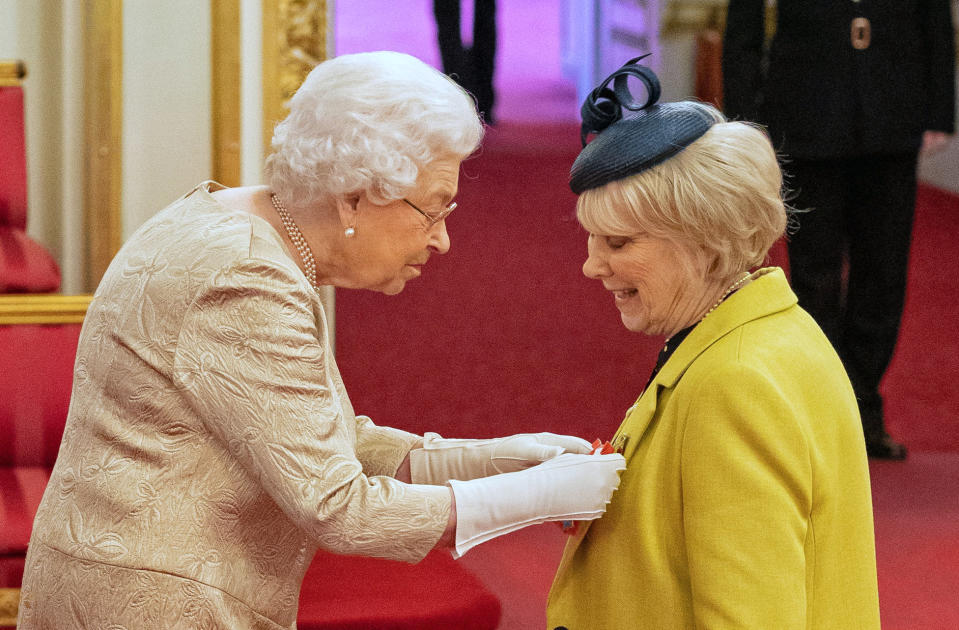 Queen Elizabeth II wears gloves as she awards the CBE (Commander of the Order of the British Empire) to Miss Anne Craig, known professionally as actress Wendy Craig, during an investiture ceremony at Buckingham Palace in London.