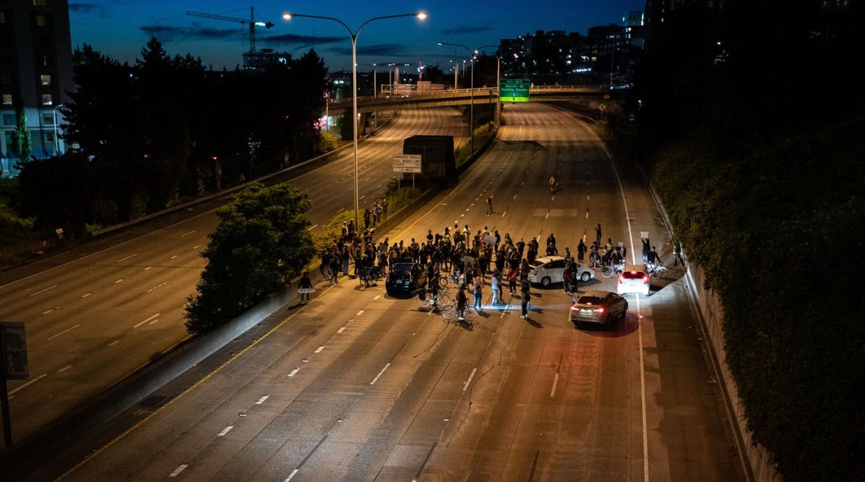 <span class="caption">When blocking a highway, who is a domestic terrorist and who is a peaceful protester? And does it make a legal difference?</span> <span class="attribution"><a class="link " href="https://www.gettyimages.com/detail/news-photo/protesters-block-interstate-5-after-marching-from-the-area-news-photo/1222748902" rel="nofollow noopener" target="_blank" data-ylk="slk:David Ryder/Getty Images;elm:context_link;itc:0;sec:content-canvas">David Ryder/Getty Images</a></span>