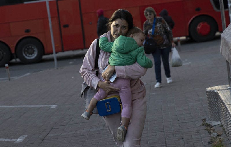 A Ukrainian woman is seen with her child after the Russian attacks in Kyiv, Ukraine on October 17, 2022. 