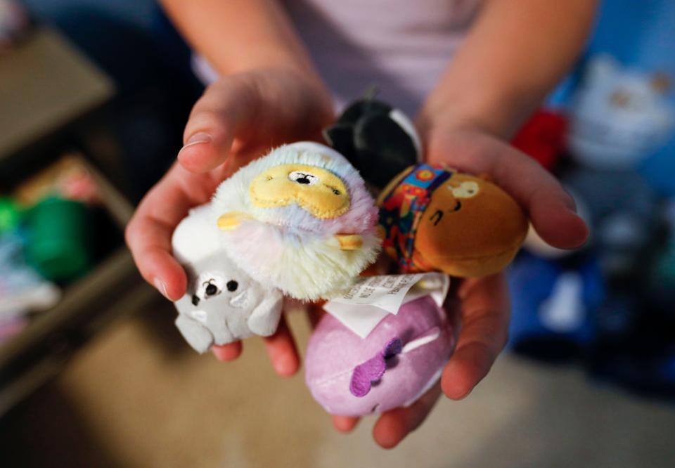 Eleven-year-old Jessica Strickland holds some of the smaller Squishmallows that she has in her collection.