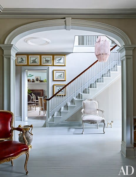 The elegant stair hall in a <a rel="nofollow noopener" href="https://www.architecturaldigest.com/gallery/bernd-goeckler-carl-d-aquino-new-york-farmhouse-slideshow?mbid=synd_yahoo_rss" target="_blank" data-ylk="slk:Hudson Valley, New York, home;elm:context_link;itc:0;sec:content-canvas" class="link ">Hudson Valley, New York, home</a> is crowned by a Venini pendant of amethyst glass; 18th-century engravings by Johann Gmelin frame the doorway. <strong>Related:</strong> <a rel="nofollow noopener" href="https://www.architecturaldigest.com/decorating-with-color?mbid=synd_yahoo_rss" target="_blank" data-ylk="slk:AD’s Guide to Decorating with Color;elm:context_link;itc:0;sec:content-canvas" class="link "><em>AD</em>’s Guide to Decorating with Color</a>