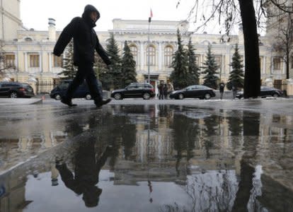 FILE PHOTO: A man walks near the Central Bank headquarters in central Moscow, Russia January 29, 2016. REUTERS/Maxim Zmeyev/File Photo