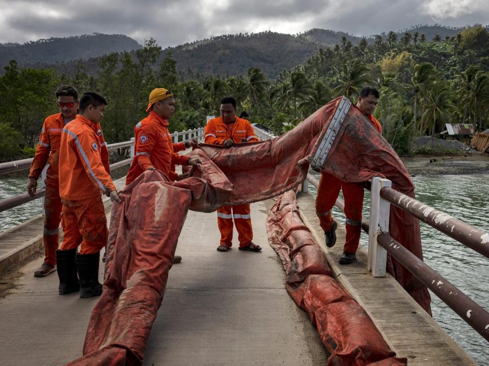 The coast guard deploys a boom to contain the oil spill on March 8, 2023, in Pola, Oriental Mindoro.