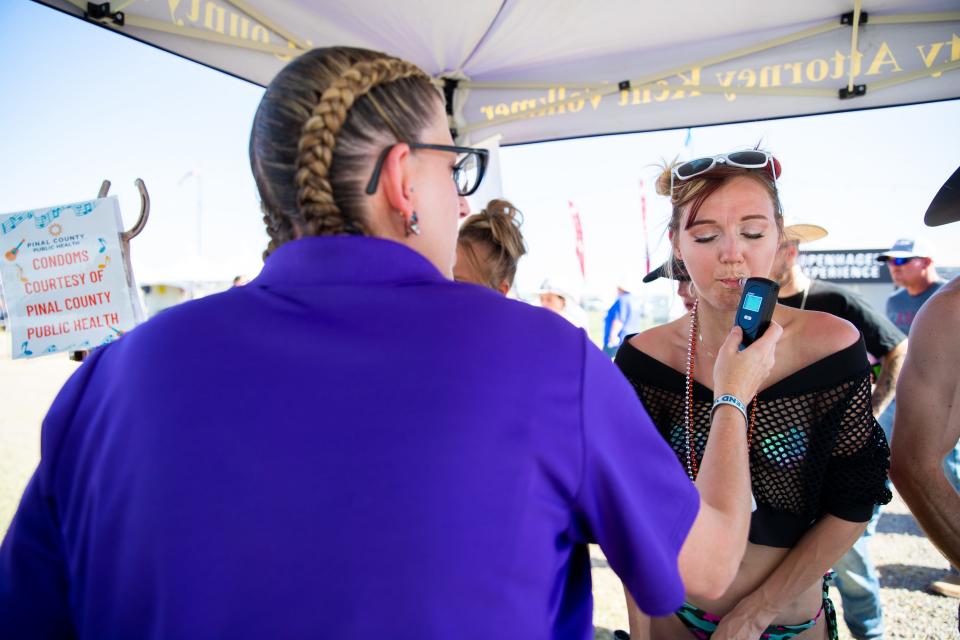 Kylie Boothe performs a breathalyzer test during the third day of Country Thunder in Florence on Friday, April 14, 2023.