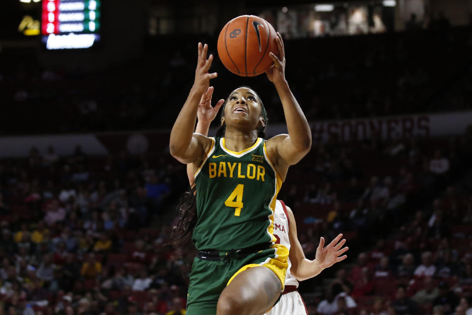 Baylor guard Te'a Cooper (4) shoots in front of Oklahoma guard Gabby Gregory, rear, in the first half of an NCAA college basketball game in Norman, Okla., Saturday, Jan. 4, 2020. (AP Photo/Sue Ogrocki)