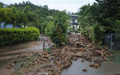 Rocks are seen blocking Muller Street in Wulguru, Townsville, as flooding continues in northern Queensland - Credit: Reuters