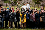 Royal aficionado Fumiko Shirataki, 78, her friends and well-wishers try to take photographs of Japan's Emperor Akihito and Empress Michiko at Kodomonokuni in Yokohama, south of Tokyo, Japan, April 12, 2019. REUTERS/Issei Kato