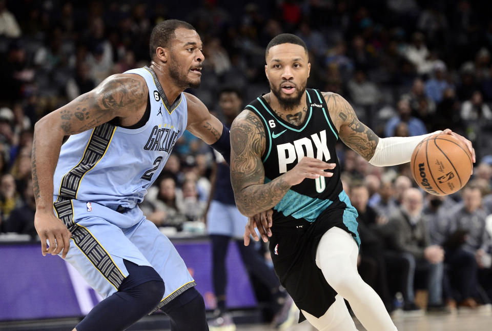 Portland Trail Blazers guard Damian Lillard (0) handles the ball against Memphis Grizzlies forward Xavier Tillman (2) in the first half of an NBA basketball game Wednesday, Feb. 1, 2023, in Memphis, Tenn. (AP Photo/Brandon Dill)