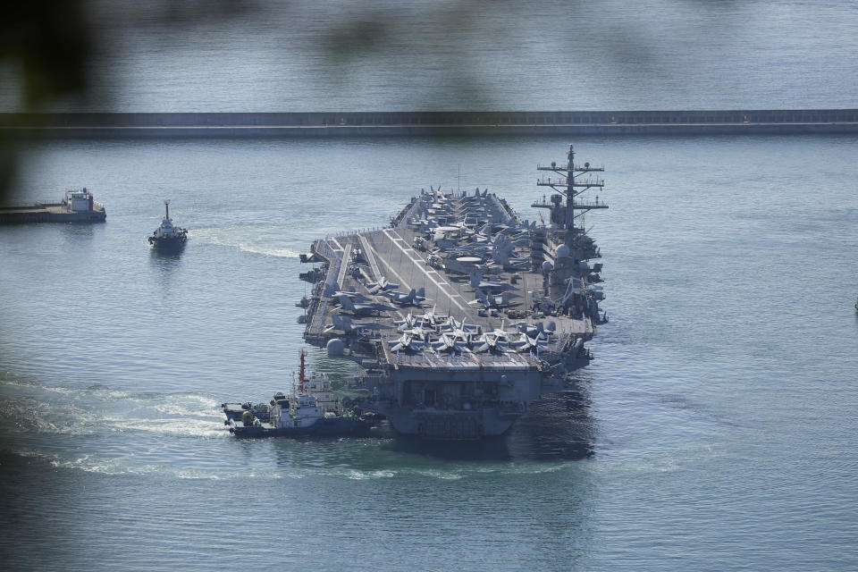 U.S. aircraft carrier USS Ronald Reagan is escorted into Busan Naval Base in Busan, South Korea, Friday, Sept. 23, 2022. The USS Ronald Reagan arrived to participate in upcoming joint military drills with South Korea in the East Sea – the first time since 2017. (AP Photo/Lee Jin-man)