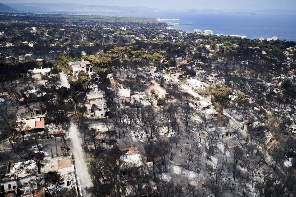 Photo shows houses destroyed in Mati by Greek wildfires. 