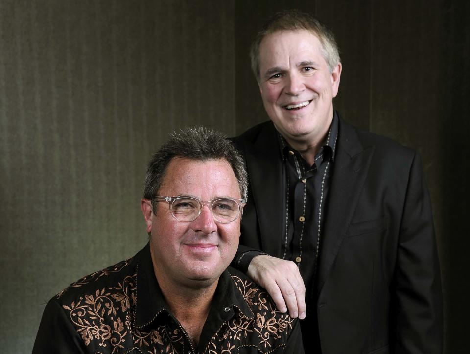 This Saturday, July 27, 2013 photo shows Vince Gill, left, and Paul Franklin posing at the Grand Ole Opry in Nashville, Tenn. Gill and Franklin released their latest album "Bakersfield," on July 30. (Photo by Donn Jones/Invision/AP)