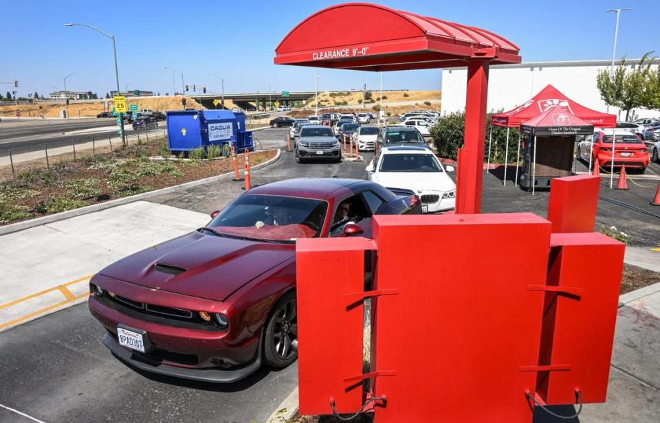 Cars pull up to the ordering kiosk in the drive-thru lane at Chick-fil-A’s River Park location at Blackstone and Nees in Fresno on Monday, Aug. 7, 2023.