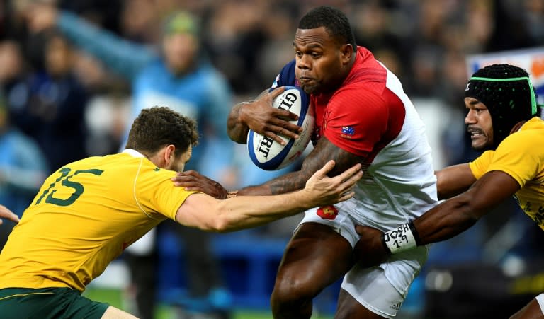 France’s left wing Virimi Vakatawa (C) runs with the ball next to Australia's full back Luke Morahan (L) at the Stade de France in Saint-Denis, outside Paris, on November 19, 2016