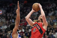 Philadelphia 76ers guard Cameron Payne fouls Toronto Raptors forward Kelly Olynyk (41) during the first half of an NBA basketball game in Toronto, Sunday, March 31, 2024. (Frank Gunn/The Canadian Press via AP)